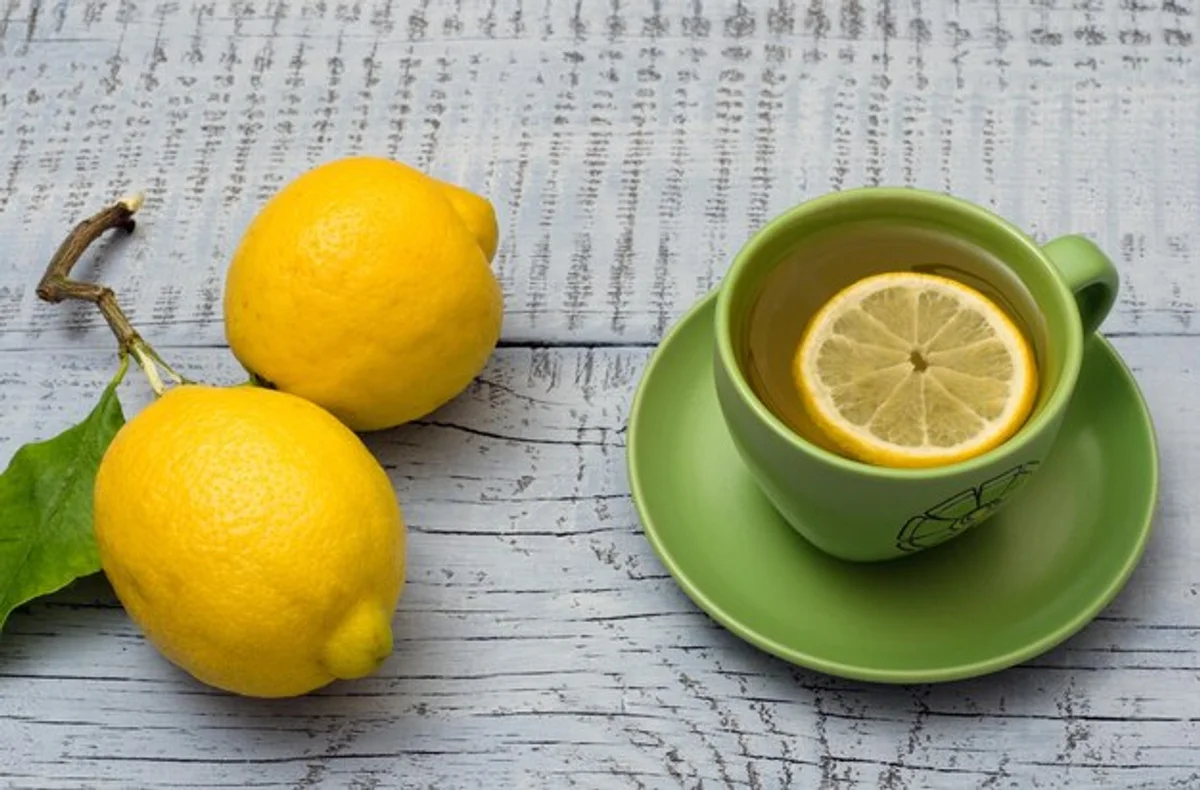 fresh lemon water on kitchen table morning sunlight