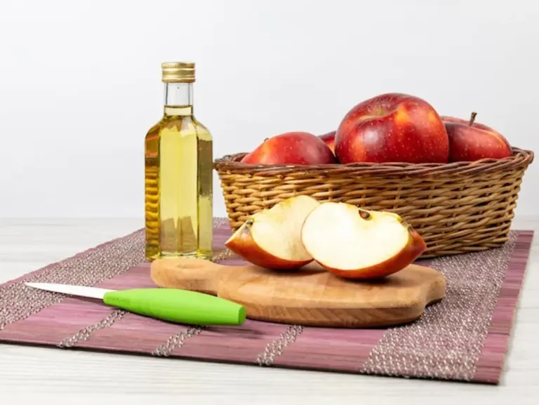 apple cider vinegar glass on kitchen table healthy lifestyle