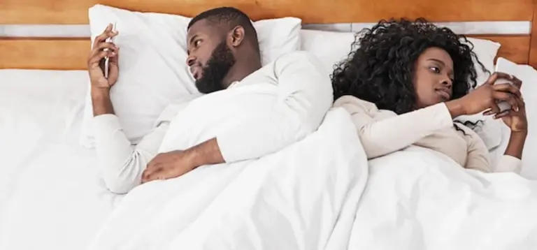 couple ignoring each other because of smartphones