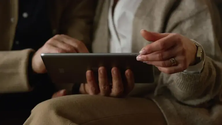 elderly hands using tablet technology
