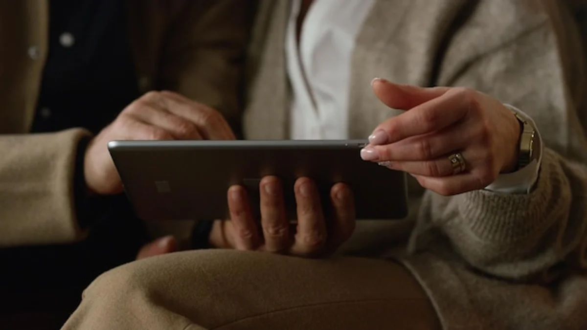 elderly hands using tablet technology