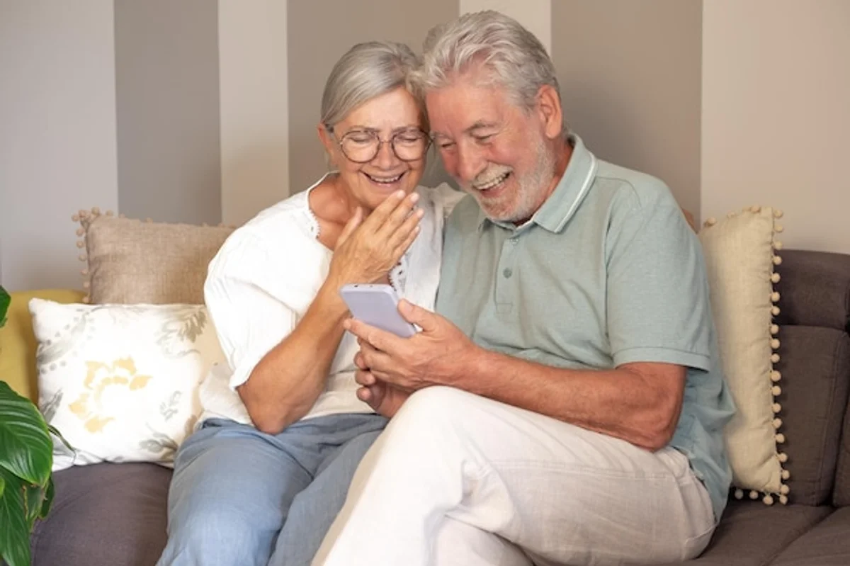 tablet user group senior hands laughing living room technology support
