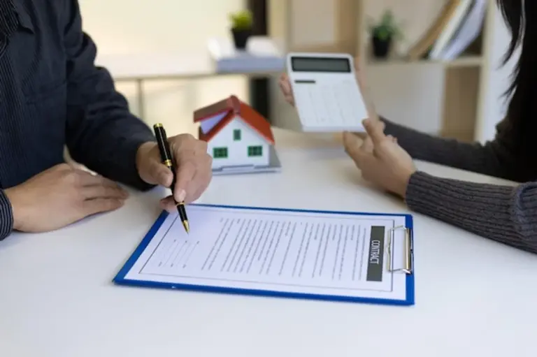 german person reviewing bills at home table calculator paperwork