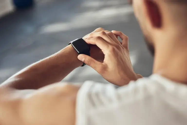 fitness tracker vs smartwatch on wrist close up