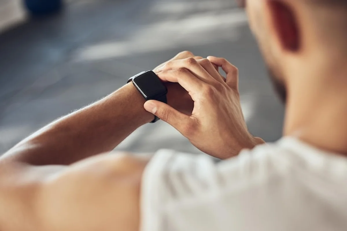 fitness tracker vs smartwatch on wrist close up
