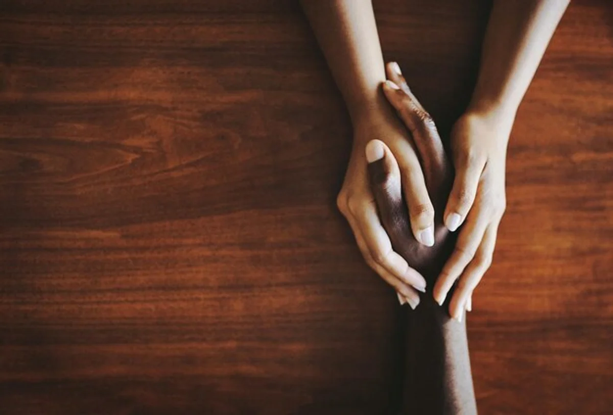 close up on hands comforting each other, silent support