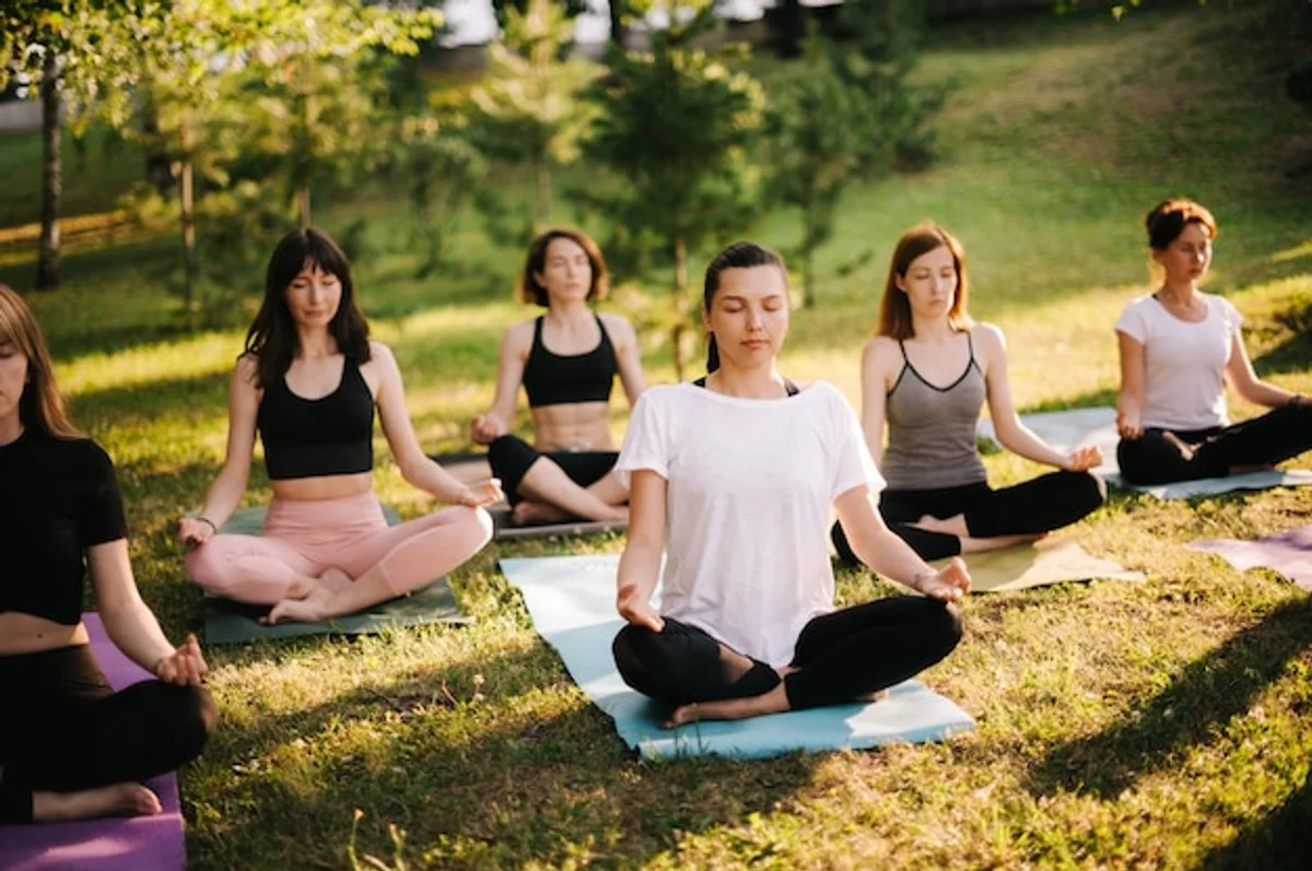 woman practicing yoga in city park morning calm