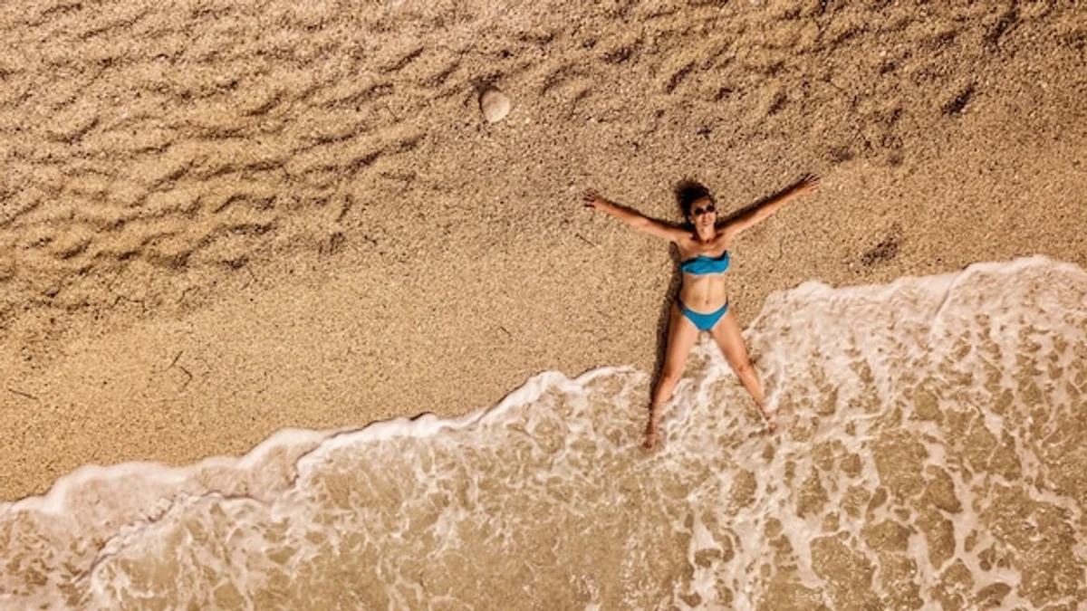 relaxed people enjoying beach holiday aerial view