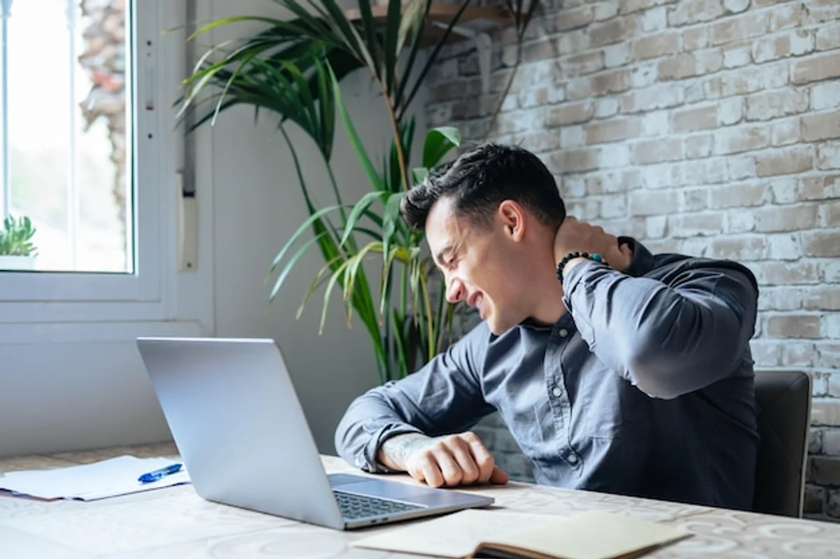 man sitting at desk tired unhealthy office lifestyle