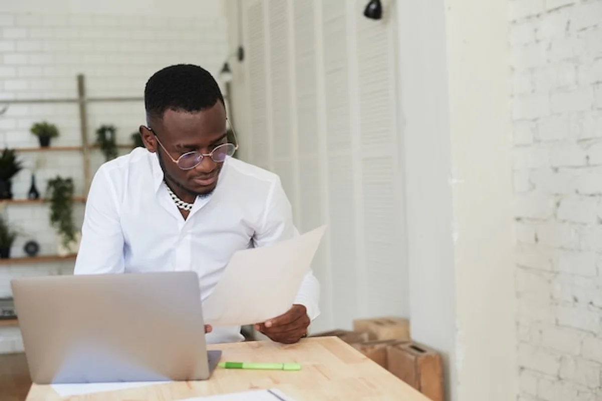 happy professional working focused on laptop in modern office