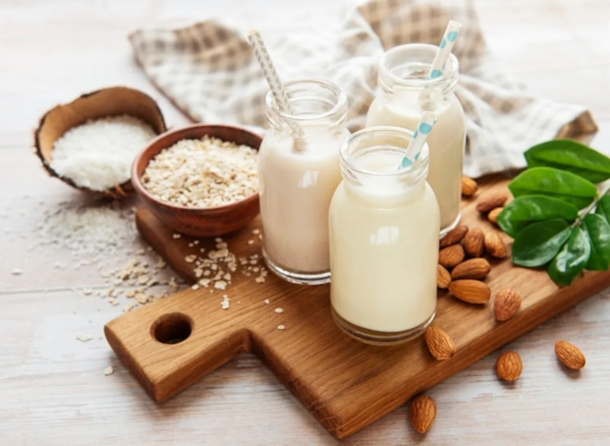 plant based milk variety in glass bottles on table