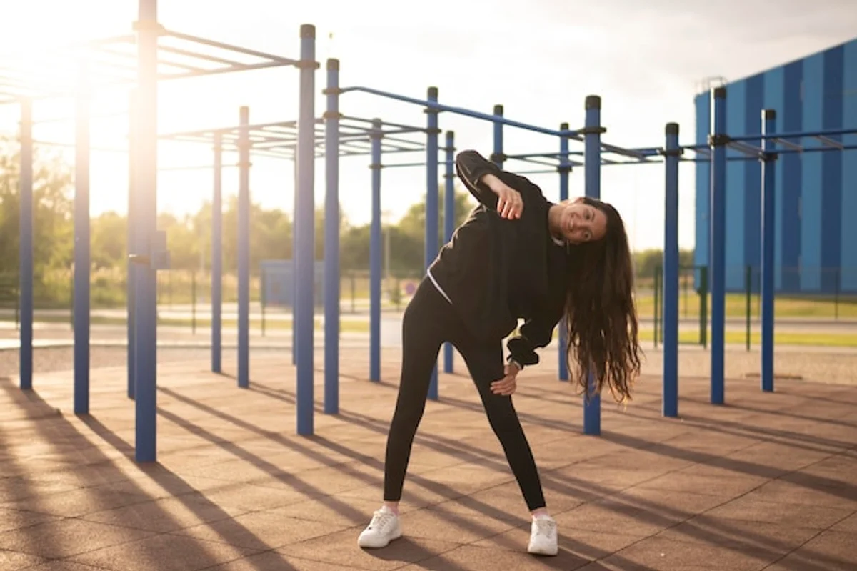 fit athlete stretching with morning sunlight