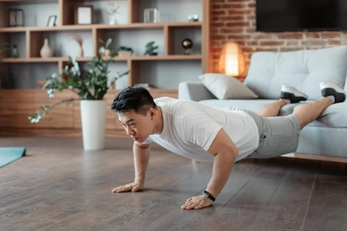 mature man home workout push ups living room