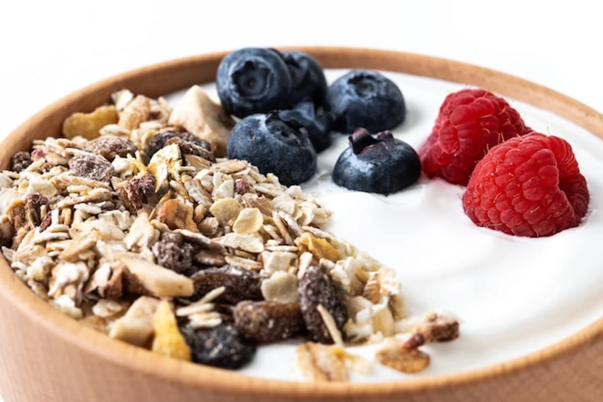 close up healthy homemade muesli bowl with berries and nuts