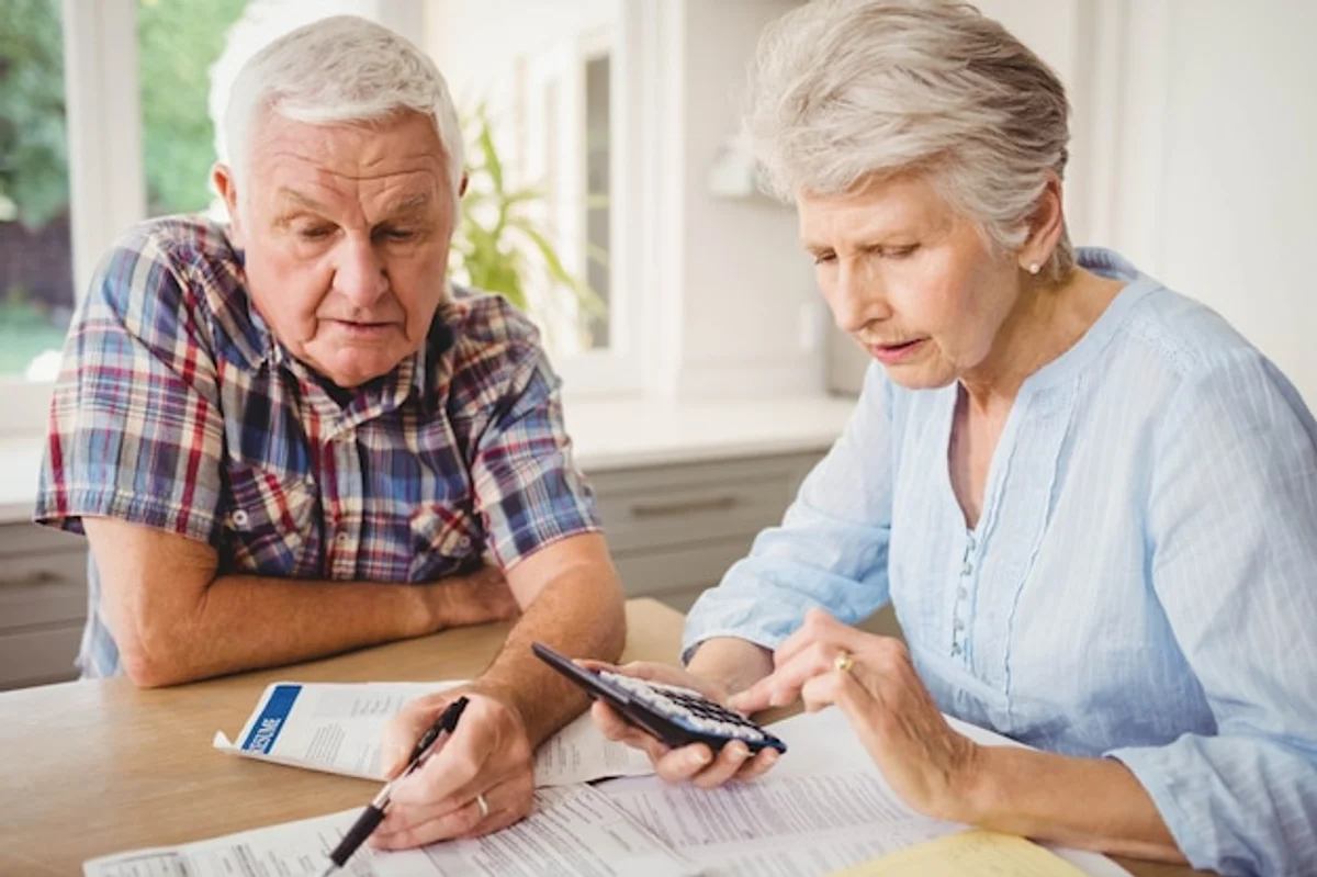 active senior couple analyzing finances at home