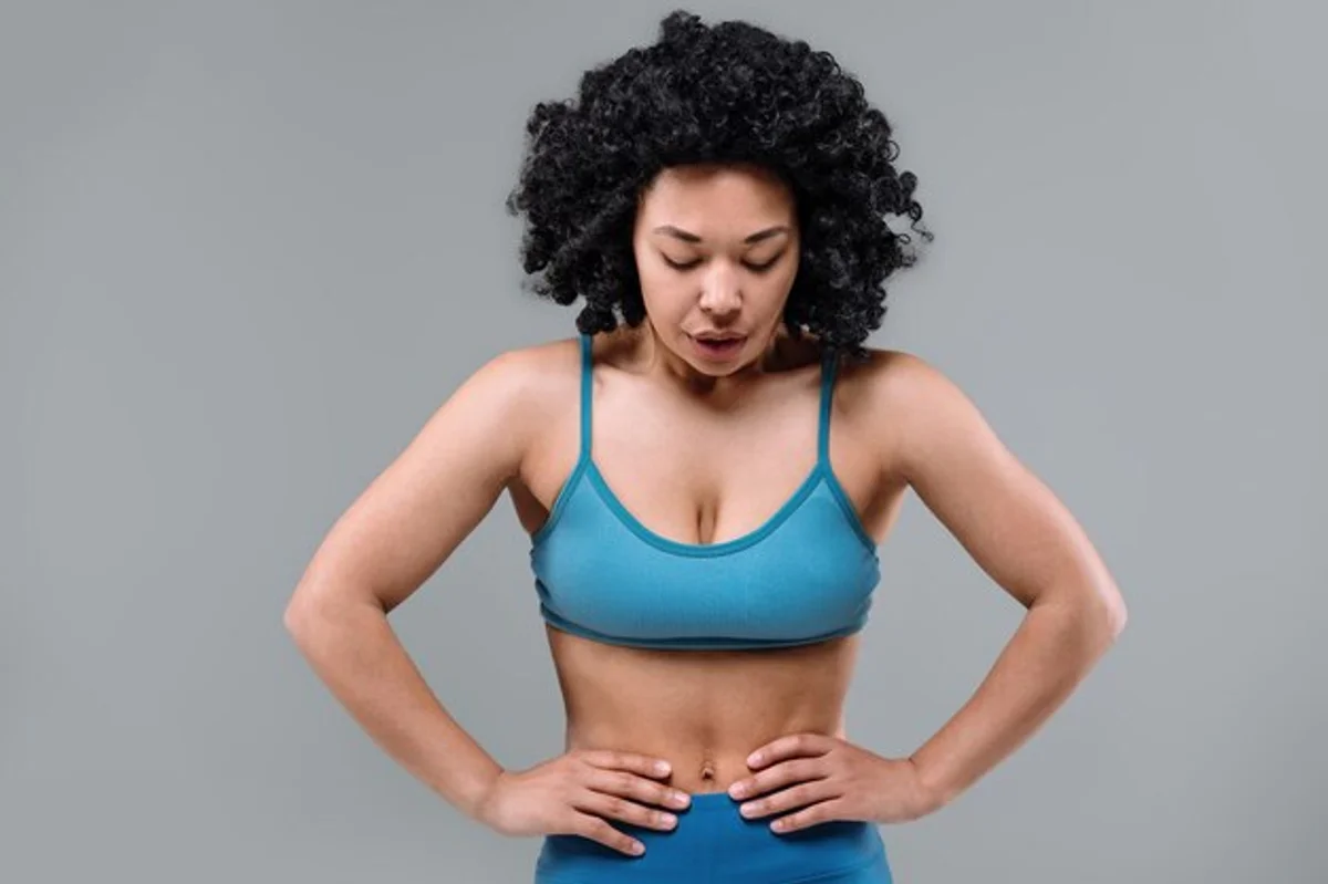 fit woman deep breathing workout gym
