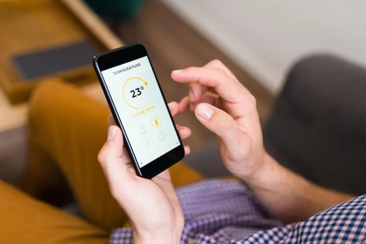 person using weather app while it's raining outside