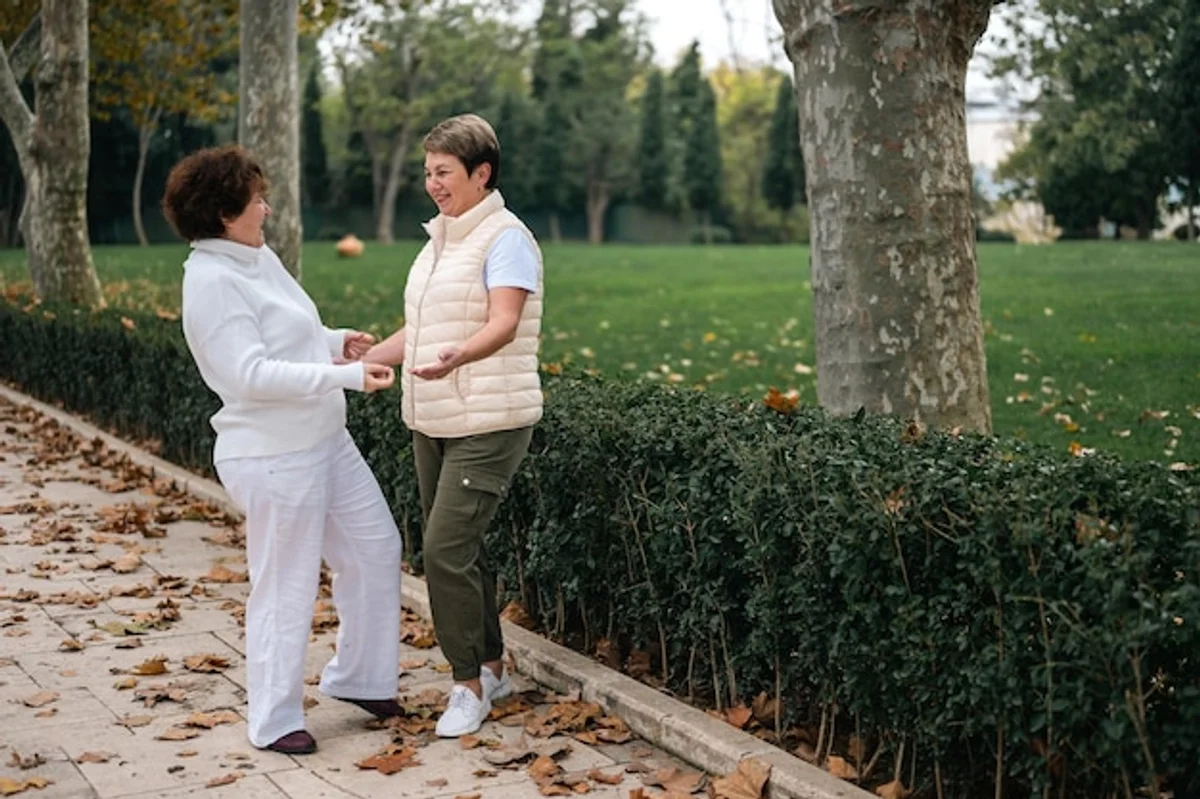 close friends talking in a park, sunlight, warm atmosphere