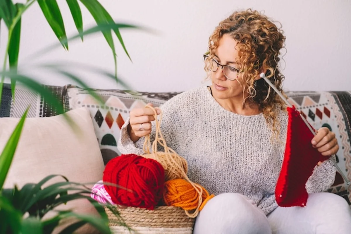woman knitting colorful wool modern cozy