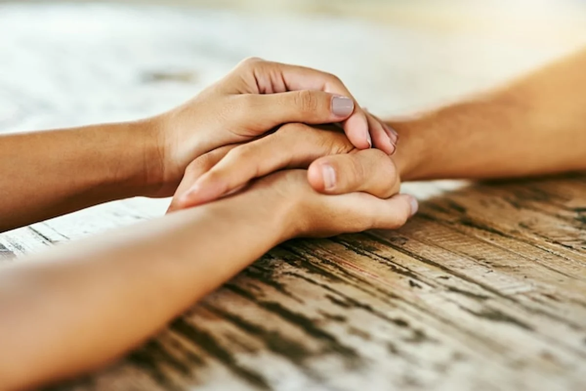 couple holding hands close up emotional connection