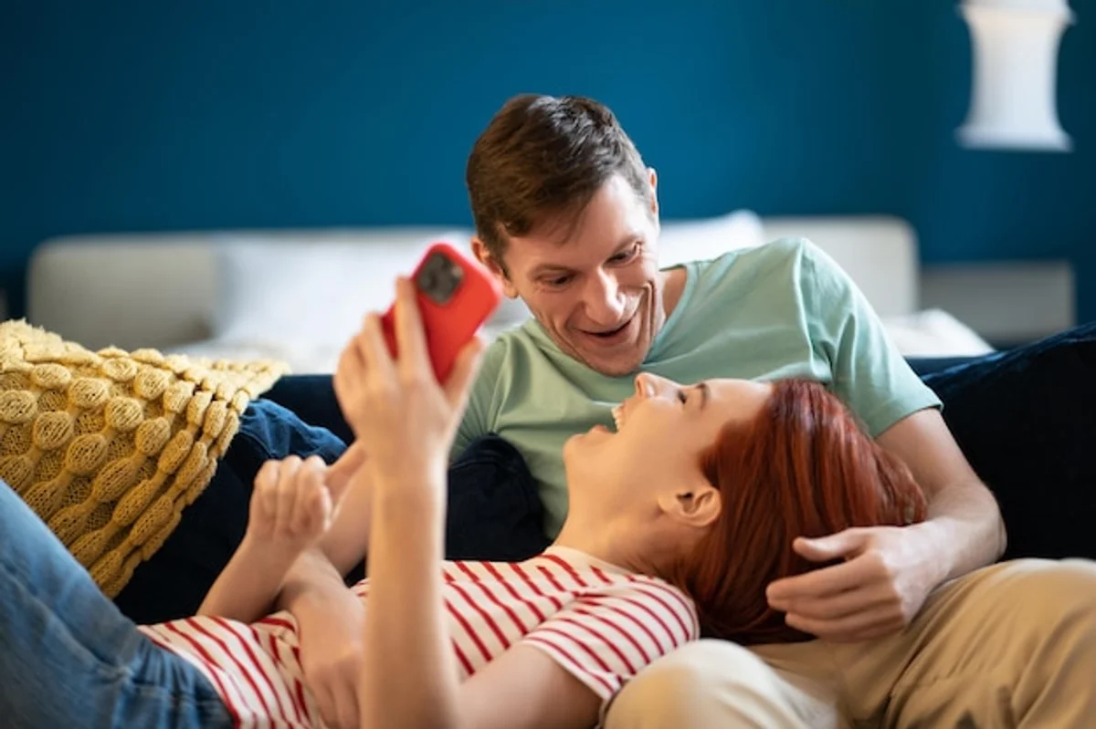 German couple talking on couch