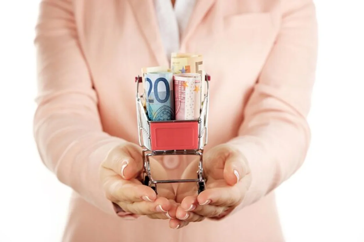 hand paying with cash in supermarket Germany