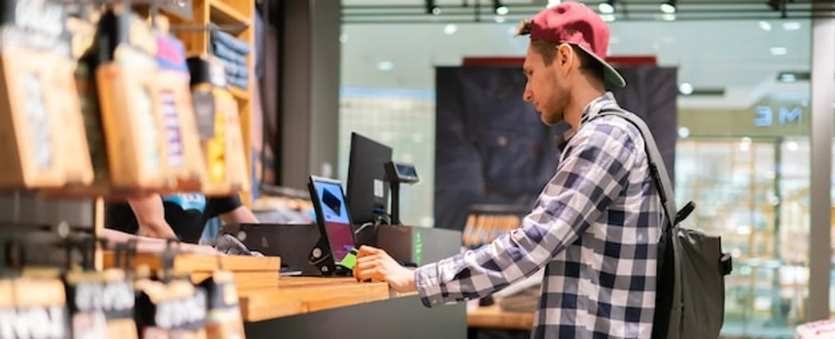 young woman paying with smartphone in a german supermarket