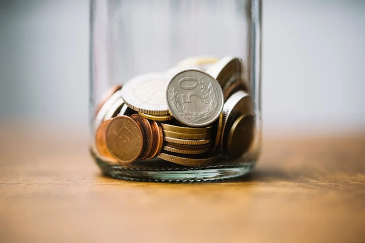 close up glass jar full of euro coins on table home finance
