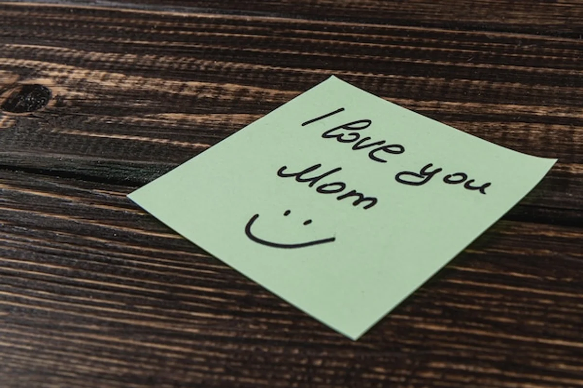 couple writing gratitude notes for each other at kitchen table