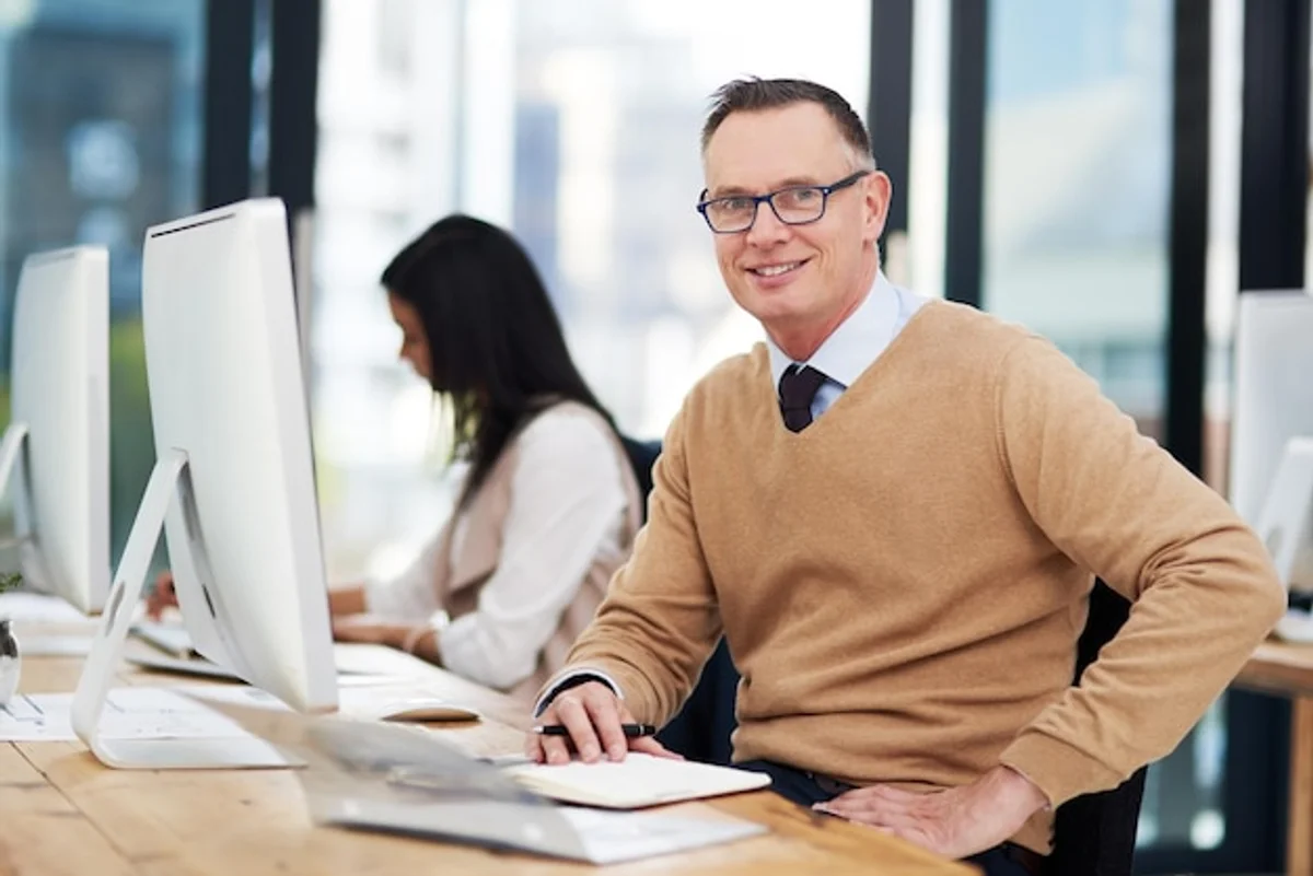 happy mature people working office Germany