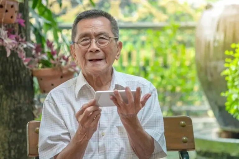 elderly person using smartphone happily