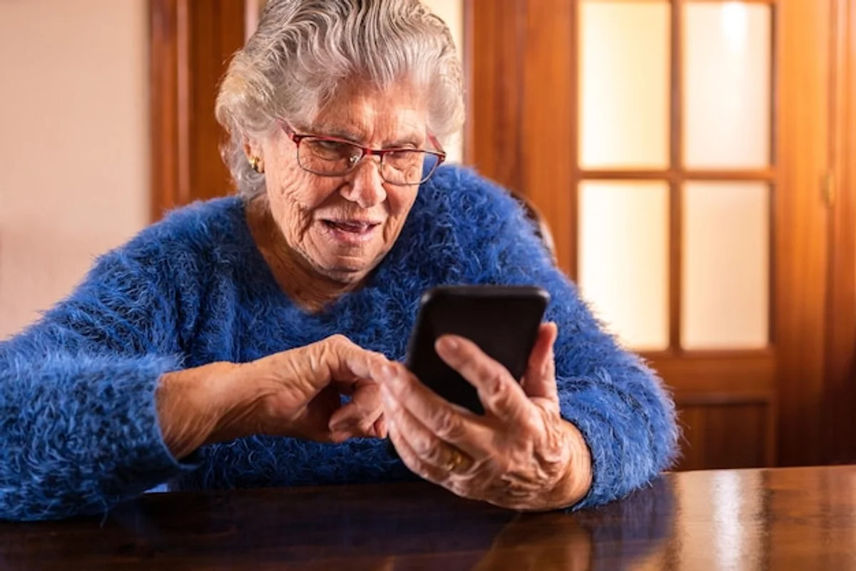 senior using smartphone simply and smiling