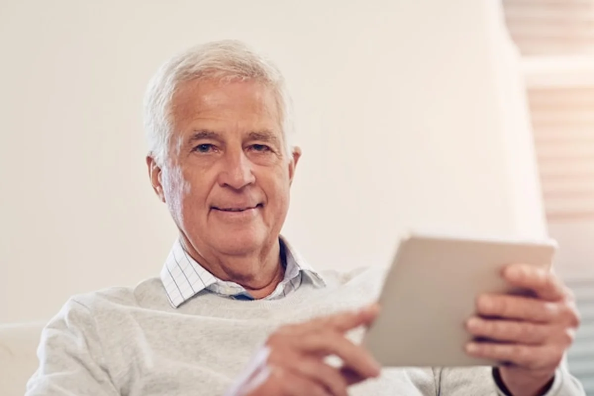 senior using tablet at home germany