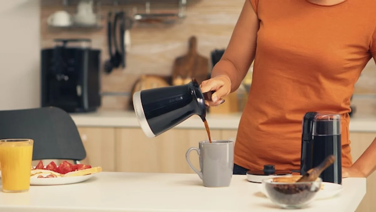 pouring filter coffee into mug morning routine