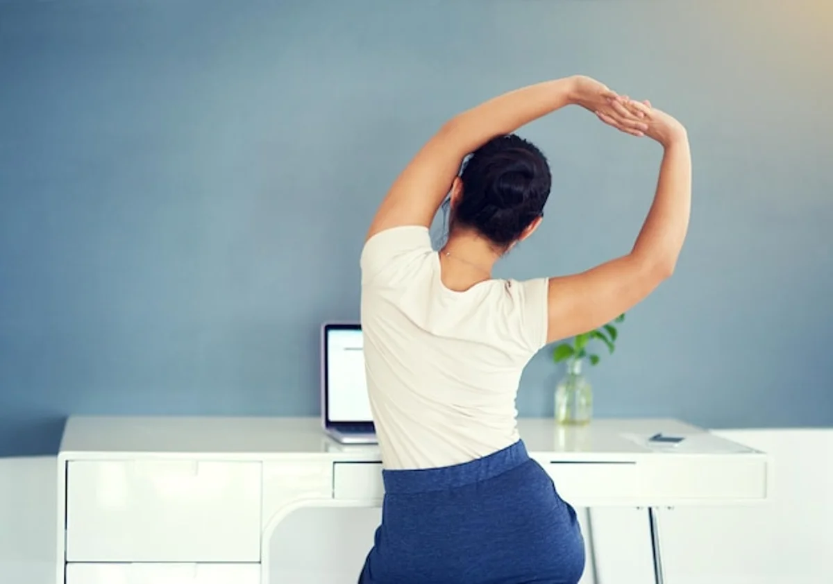 office worker stretching back pain prevention