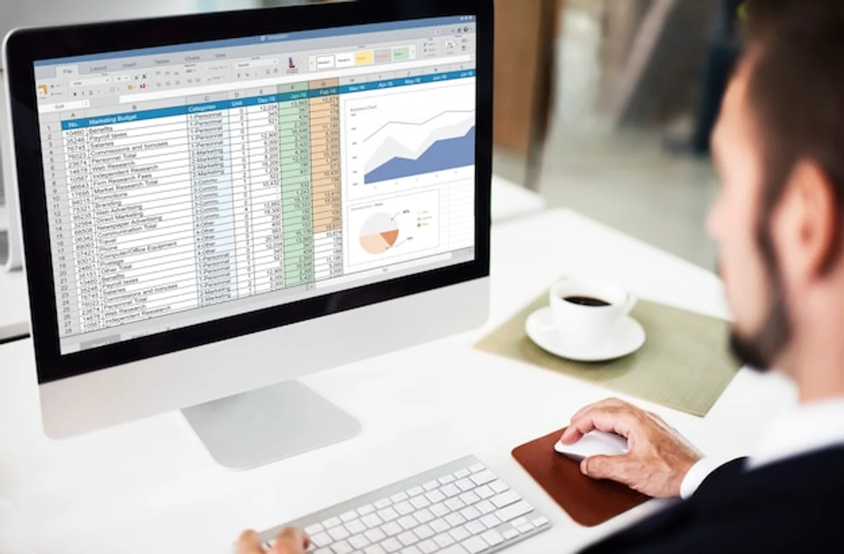 Excel Pivot table analysis on laptop screen, everyday business context