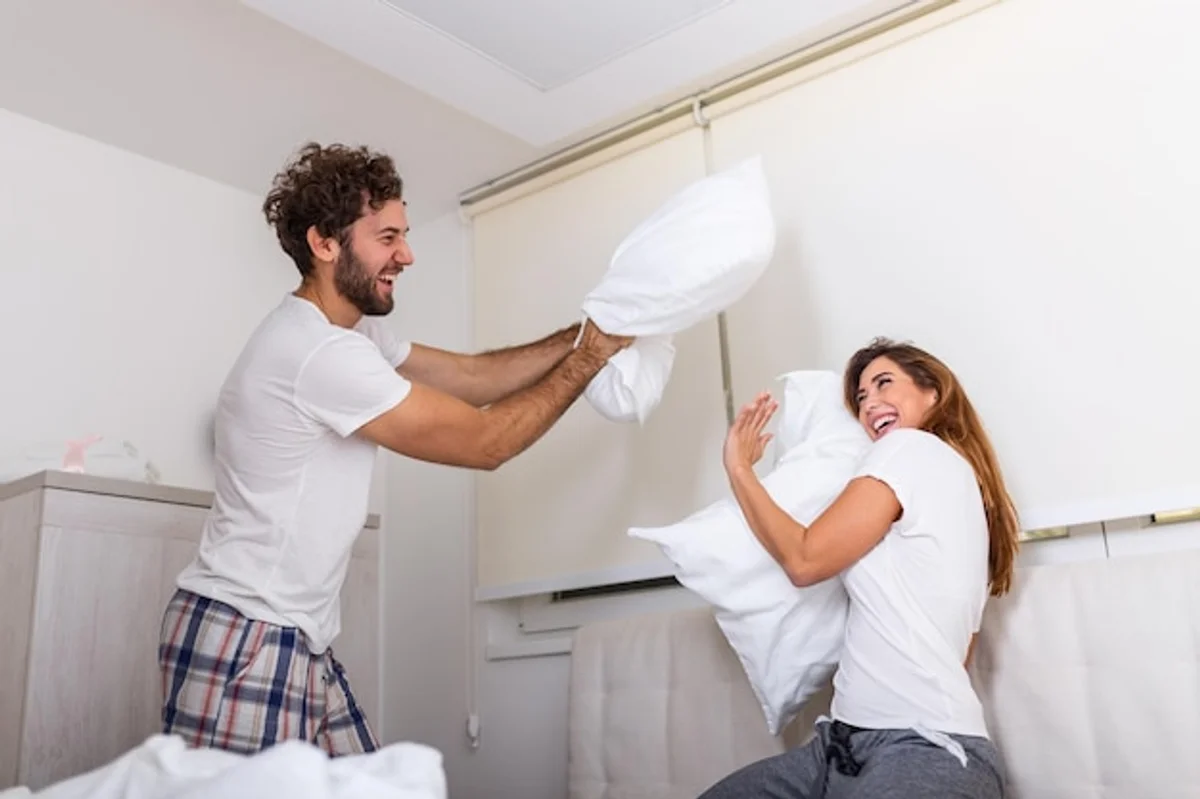funny couple pillow fight at home