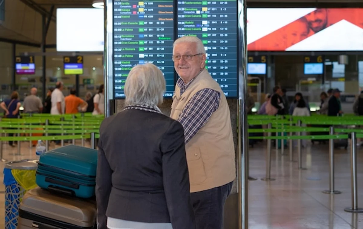 senior couple travel safety airport suitcase