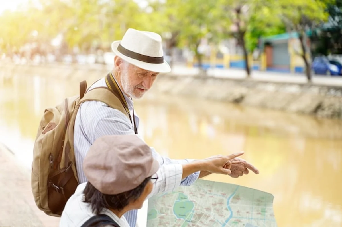 active senior tourist exploring city map