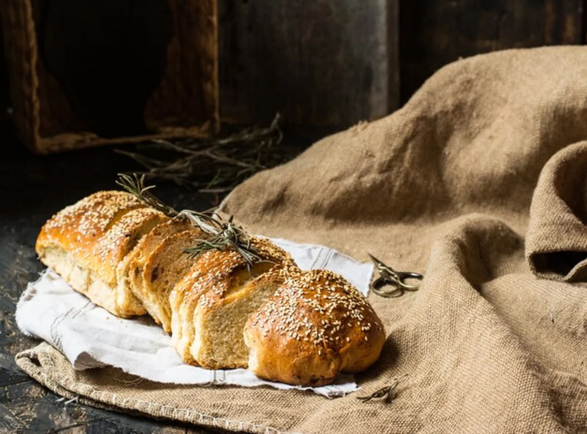 fresh homemade bread in linen bag on dark background