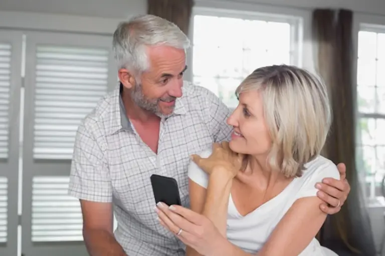 couple looking at old smartphone messages together