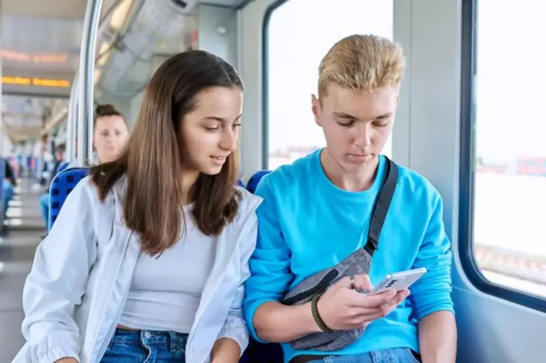 commuters ignoring each other on subway smartphones