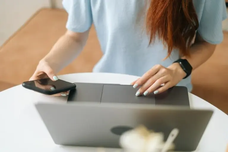 senior using tablet and smartwatch modern home