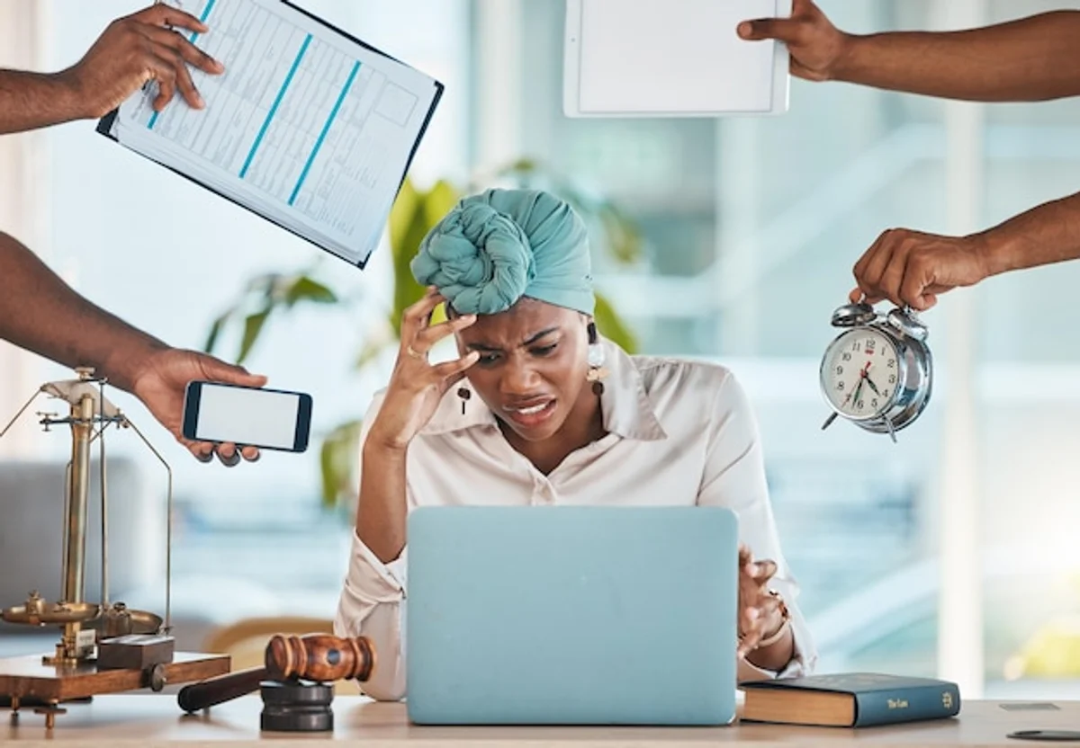 overwhelmed office worker emails meetings stress