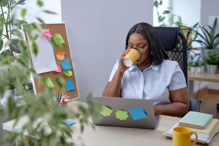 young professional drinking green tea office desk