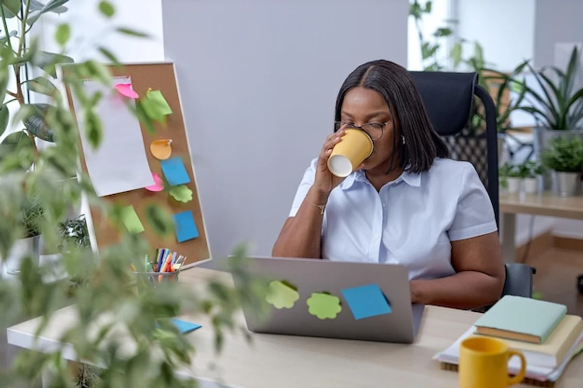 young professional drinking green tea office desk