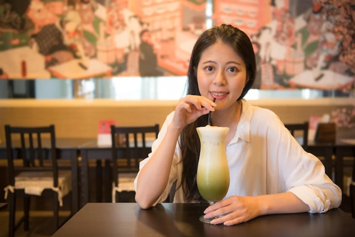 japanese office worker drinking green tea at desk